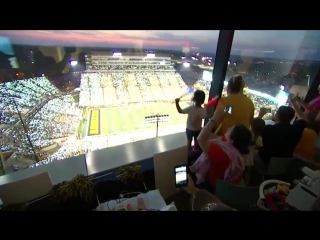 fans of the university of iowa football team wave to teen from a nearby hospital.