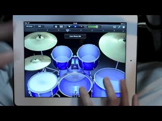 a virtuoso drummer plays on an ipad